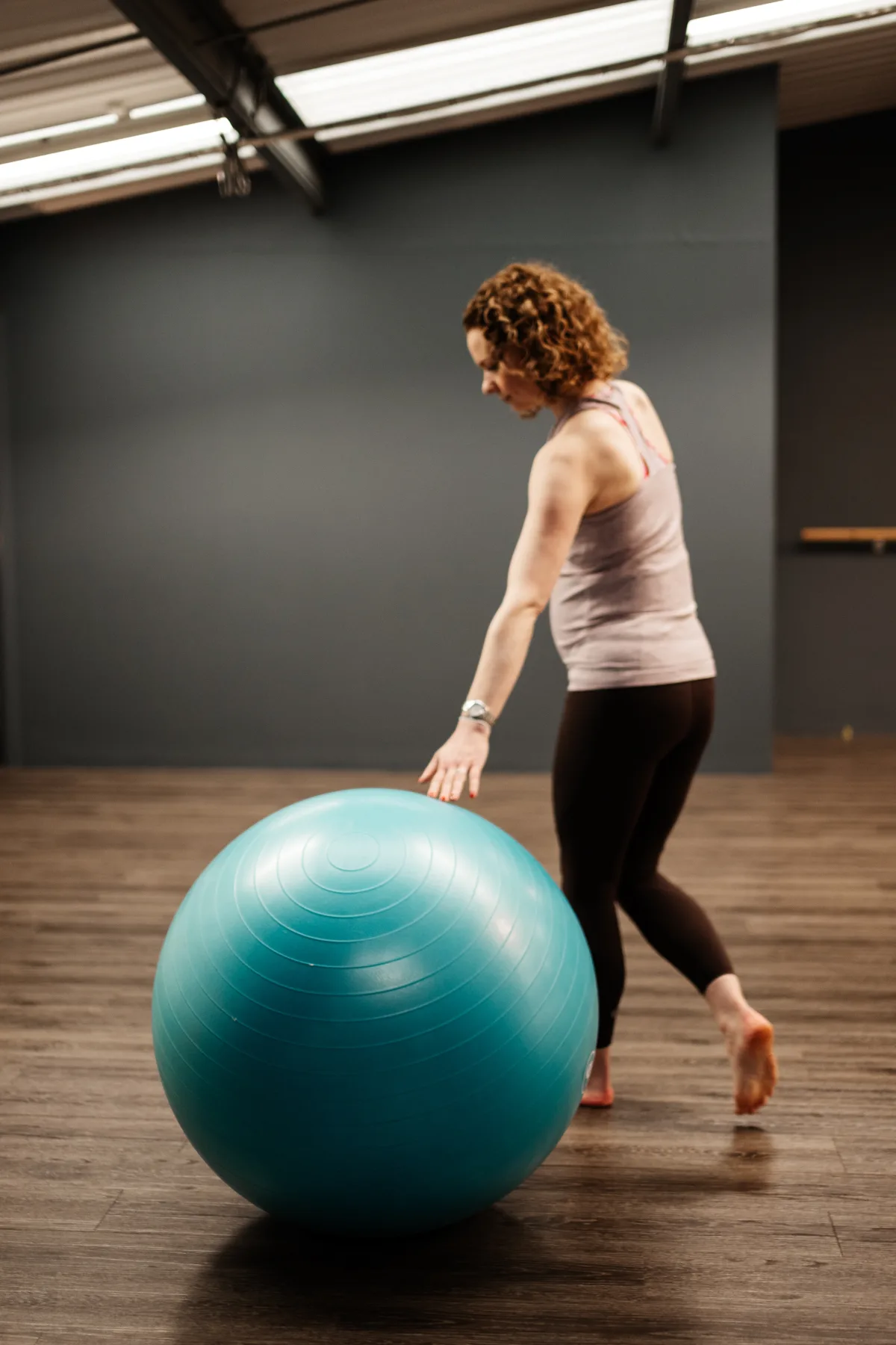 A mum-to-be practising with a birthing ball in the studio